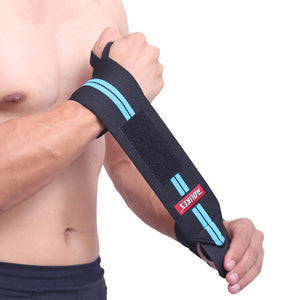 A person is wearing a black wristband with a blue stripe, fastened with a Velcro closure.